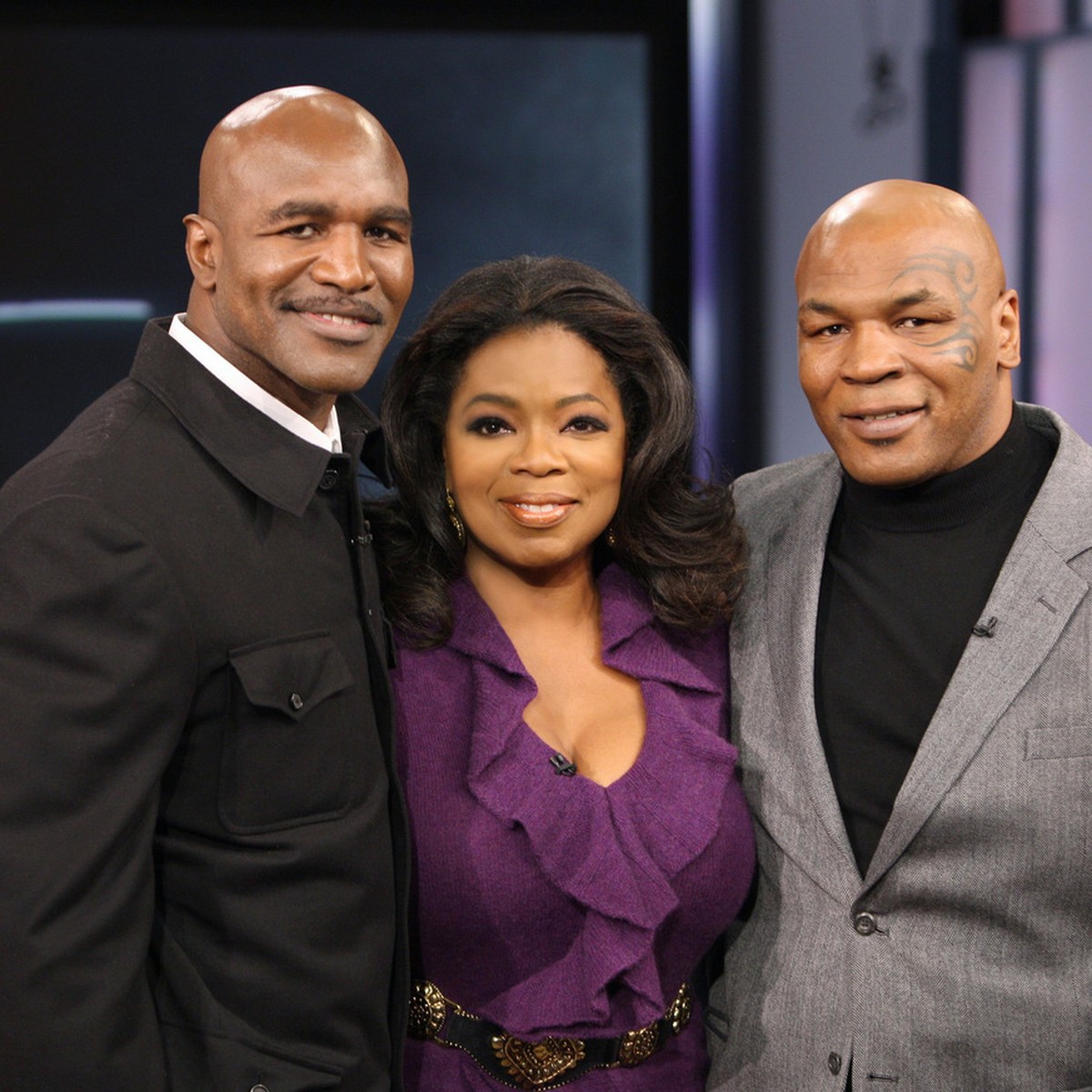 In this photo provided by Harpo, Inc., talk-show host Oprah Winfrey poses with former world champion boxers Mike Tyson, right, and Evander Holyfield on a live episode of "The Oprah Winfrey Show,& ...