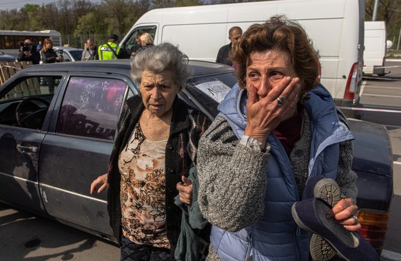 epa09922167 Natalia (R) and her mother Dina (L) react after arriving from Mariupol to an evacuation point in Zaporizhzhia, Ukraine, 02 May 2022. Thousands of people who still remain trapped in Mariupo ...