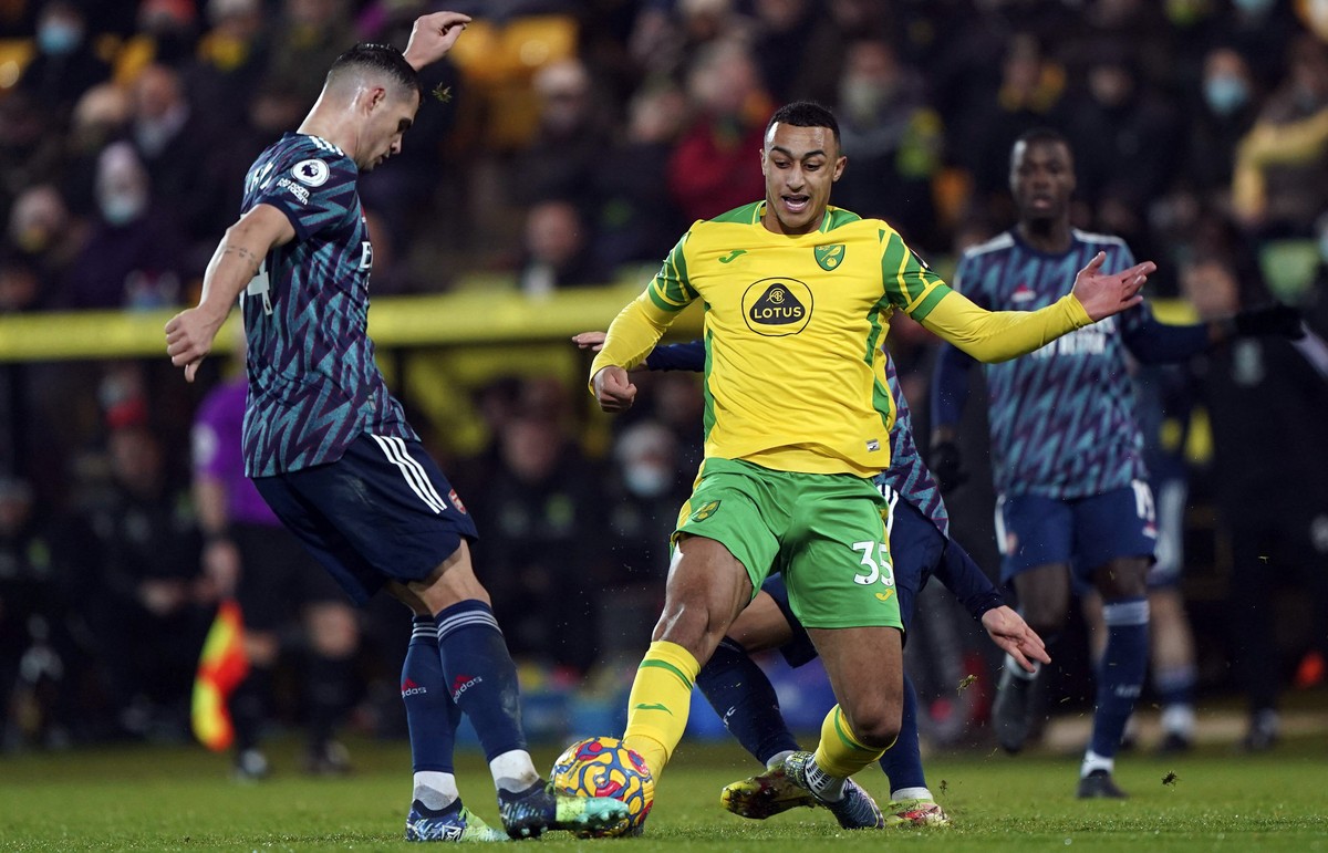 Arsenal's Granit Xhaka, left, and Norwich City's Adam Idah battle for the ball during the English Premier League soccer match between Norwich City and Arsenal at Carrow Stadium, Norwich, Eng ...