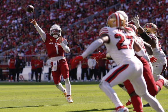 Arizona Cardinals quarterback Kyler Murray, left, throws a touchdown pass during the second half of an NFL football game against the San Francisco 49ers, Sunday, Sept. 21, 2025, in Santa Clara, Calif. ...