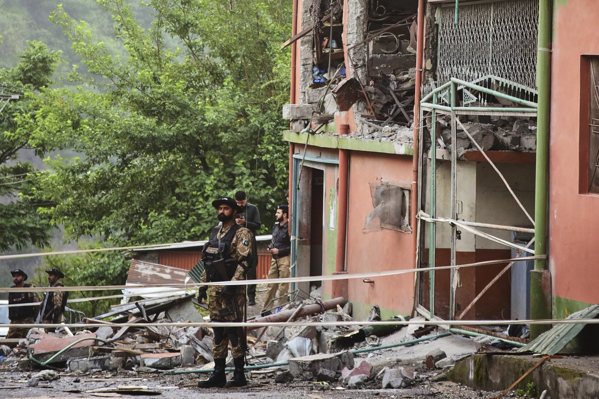 Army soldiers stand guard at a mosque building damaged by a suspected Indian missile attack near Muzaffarabad, the capital of Pakistan controlled Kashmir, on Wednesday, May 7, 2025. (AP Photo/M.D. Mug ...
