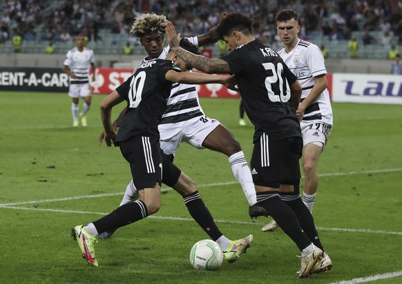 Basel&#039;s Andy Pelmard, centre, fights for the ball with Qarabag&#039;s Abdellah Zoubir, left, and Qarabag&#039;s Kady during the Europa Conference League, group H, soccer match between FK Qarabag  ...