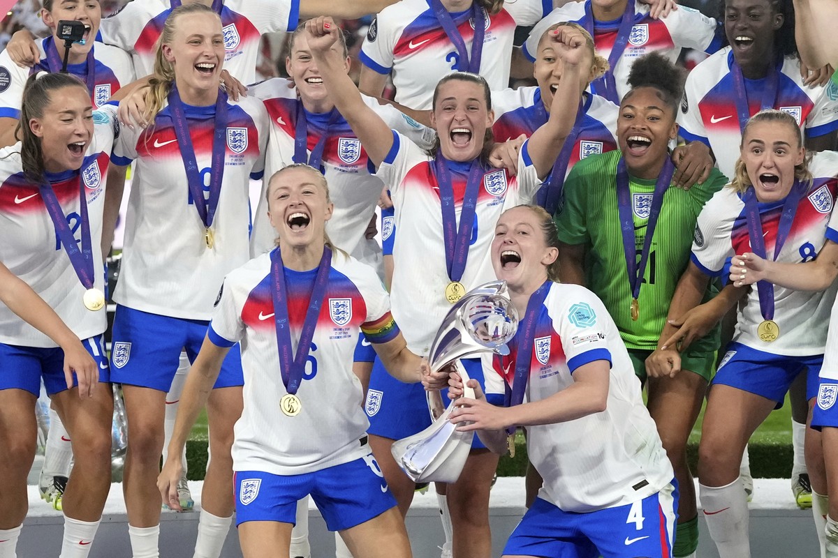 England's Leah Williamson, center left, and Keira Walsh lift the trophy after winning the Women's Euro 2025 final soccer match between England and Spain at St. Jakob-Park in Basel, Switzerla ...