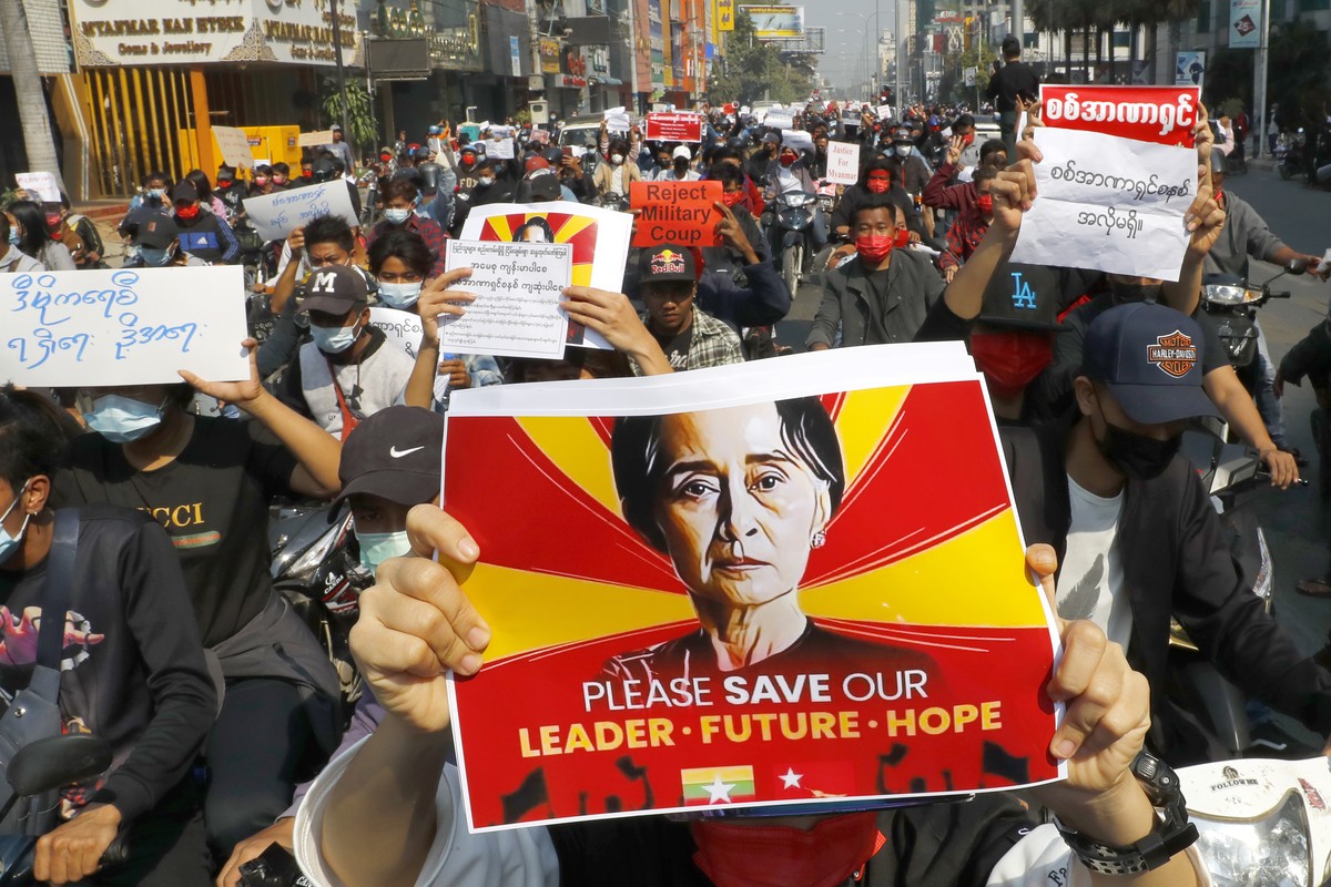 A protester holds an image of deposed Myanmar leader Aung San Suu Kyi as fellow protesters march around Mandalay, Myanmar on Monday, Feb. 8, 2021. A protest against Myanmar's one-week-old militar ...