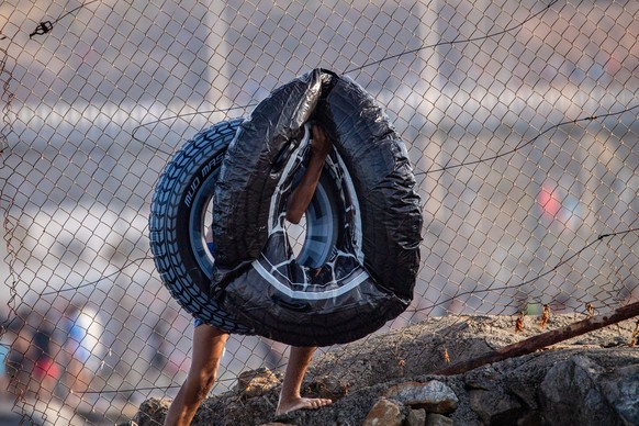 A migrant carries inflatable floats used to cross from Morocco into the Spanish enclave of Ceuta, Thursday, July 30, 2026. (AP Photo/Antonio Sempere)
Spain Ceuta