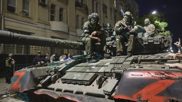 FILE - Membes of the Wagner Group military company sit atop of a tank on a street in Rostov-on-Don, Russia, Saturday, June 24, 2023, prior to leaving an area at the headquarters of the Southern Milita ...