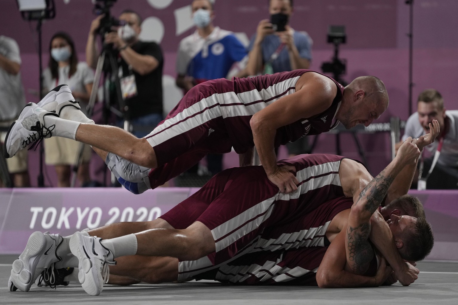 Members of team Latvia celebrate after defeating Russian Olympic Committee to win the men&#039;s 3-on-3 basketball gold medal at the 2020 Summer Olympics, Wednesday, July 28, 2021, in Tokyo, Japan. (A ...