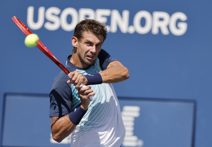 epa09445789 Henri Laaksonen of Switzerland hits a return to Peter Gojowczyk of Germany on the fifth day of the US Open Tennis Championships the USTA National Tennis Center in Flushing Meadows, New Yor ...