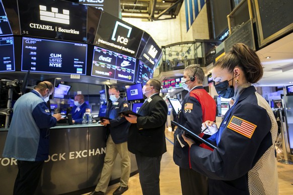 In this photo provided by the New York Stock Exchange, trader Samantha Tavares, right, works with colleagues on the floor, Wednesday, Jan. 27, 2021. Stocks were broadly lower in afternoon trading Wedn ...