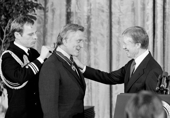 FILE - In this Jan. 16, 1981 file photo, President Jimmy Carter, right, congratulates actor Kirk Douglas upon receiving the Medal of Freedom, the nation&#039;s highest civilian honor, at the White Hou ...