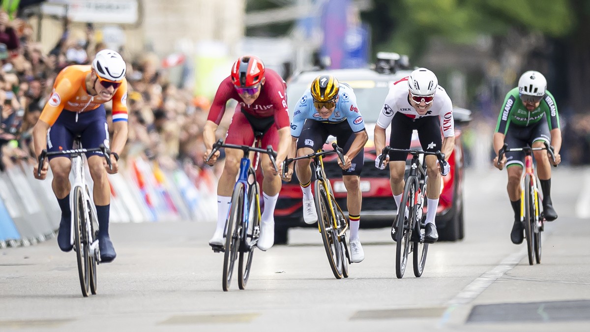 Mathieu van der Poel of Netherlands, Toms Skujins of Latvia, Remco Evenepoel of Belgium and Marc Hirschi of Switzerland, left to right, cross the finish line during the Men Elite Road Race at the 2024 ...