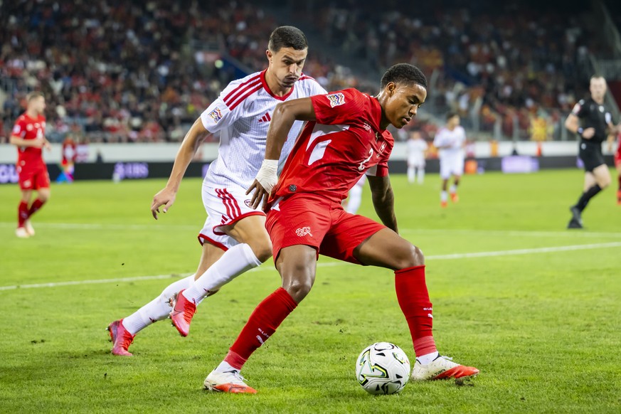 epa13285614 North Macedonia's Elmin Rastoder, left, fights for the ball with Switzerland's Sascha Britschgi, right, during the UEFA Nations League group stage soccer match between Switzerlan ...