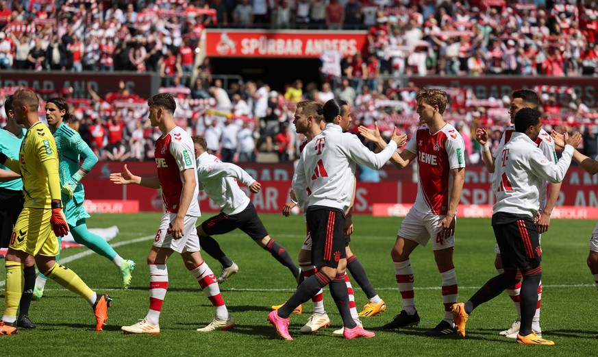 epa10657386 Players of Cologne and Munich shake hands prior the German Bundesliga soccer match between 1.FC Cologne and FC Bayern Munich, in Cologne, Germany, 27 May 2023. EPA/ANNA SZILAGYI CONDITIONS ...