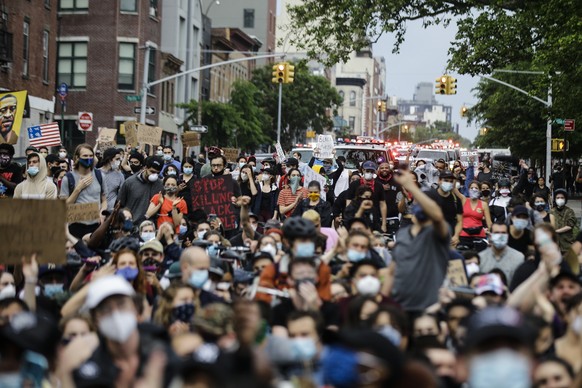 Protesters march during a solidarity rally for George Floyd, Friday, June 5, 2020, in the Brooklyn borough of New York. Floyd died after being restrained by Minneapolis police officers on May 25. (AP  ...