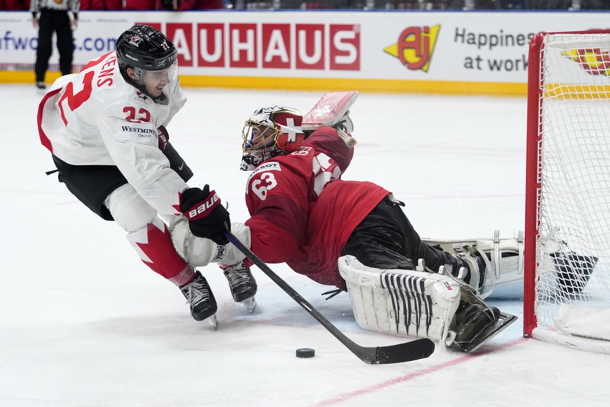 Switzerland's goalkeeper Leonardo Genoni, right, makes a save against Canada's Dylan Cozens during penalty shootout of the semifinal match between Canada and Switzerland at the Ice Hockey Wo ...