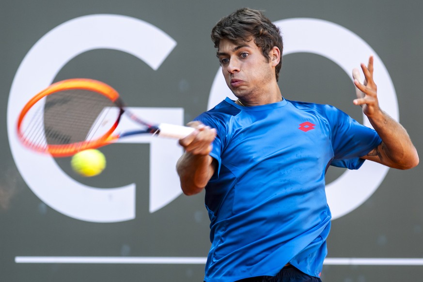 Flavio Cobolli, of Italy, returns a ball to Casper Ruud, of Norway, during their semi-final match, at the ATP 250 Geneva Open tennis tournament in Geneva, Switzerland, Saturday, May 25, 2024. (KEYSTON ...