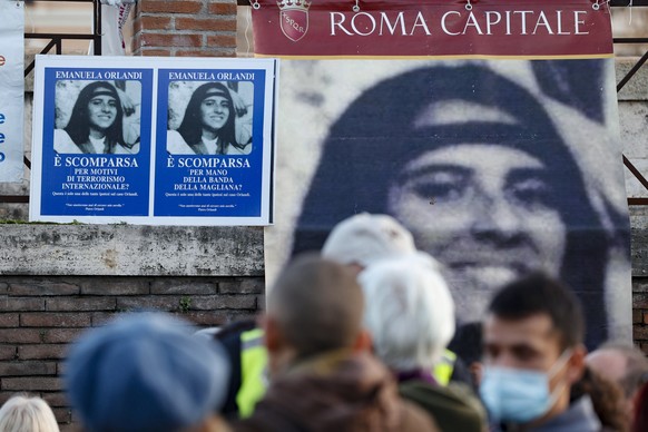 epa10405630 Posters of Emanuela Orlandi, a Vatican teenager who disappeared in 1983 at age 15, hang on a wall at a rally along Via della Conciliazione near Vatican City, in Rome, Italy, 14 ja...