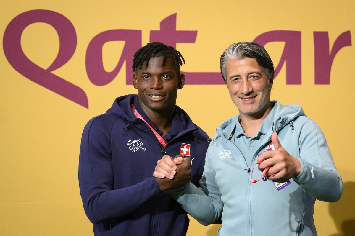 Switzerland's head coach Murat Yakin, right, and Switzerland's forward Breel Embolo, left, pose for photographers on the green carpet before a press conference of the Swiss national soccer t ...