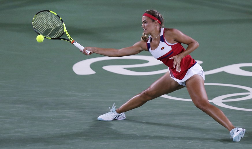 Monica Puig, of Puerto Rico, returns to Angelique Kerber, of Germany during their final round match at the 2016 Summer Olympics in Rio de Janeiro, Brazil, Saturday, Aug. 13, 2016. (AP Photo/Charles Kr ...