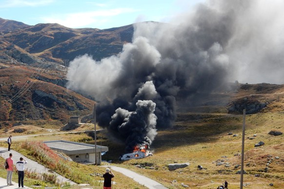 The burning debris oft the crashed Swiss army helicopter in alps near the fort Sasso da Pigna near the Gotthard mountain pass in Airolo, southern Switzerland on Wednesday September 28, 2016. The accid ...