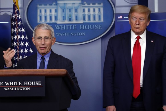 President Donald Trump listens as Dr. Anthony Fauci, director of the National Institute of Allergy and Infectious Diseases, speaks about the coronavirus in the James Brady Press Briefing Room of the W ...
