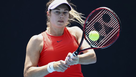 Stefanie Voegele of Switzerland plays a backhand return to Daria Kasatkina of Russia during their first round match at the Australian Open tennis championships in Melbourne, Australia, Tuesday, Jan. 1 ...