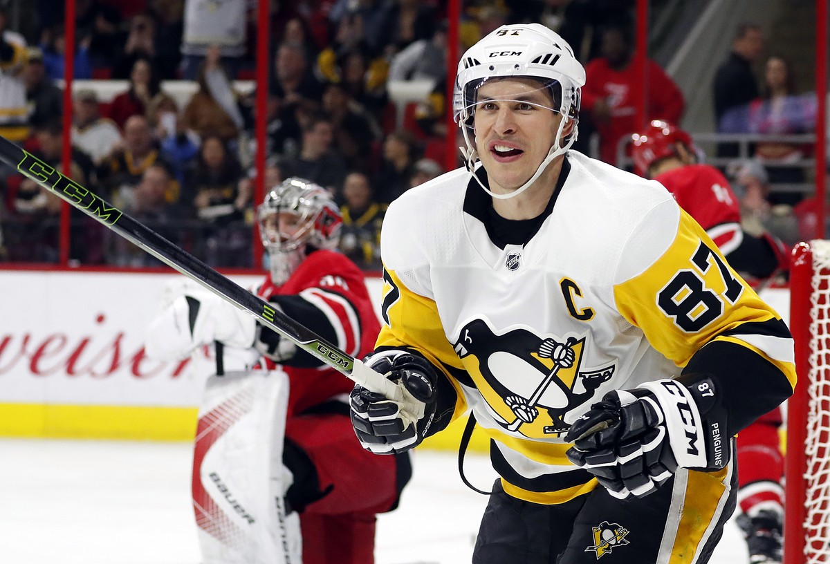 Pittsburgh Penguins' Sidney Crosby (87) looks to celebrate Brian Dumoulin's goal during the first period of an NHL hockey game against the Carolina Hurricanes, Friday, Dec. 29, 2017, in Rale ...