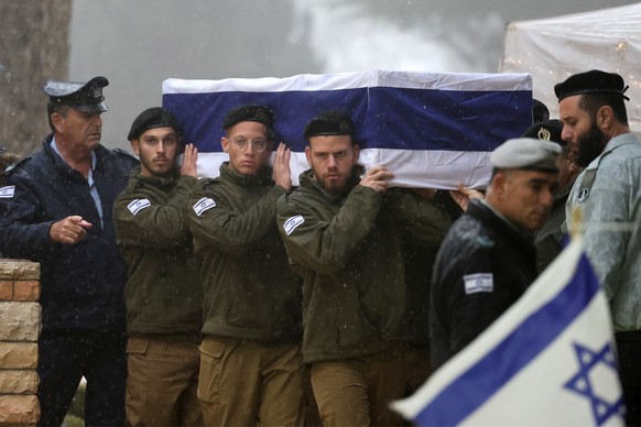 epa11098593 Israeli soldiers carry the coffin of an Israeli IDF soldier Elkana Vizel during his funeral at the Mount Herzl military cemetery in Jerusalem, 23 January 2024. Elkana Vizel was killed in b ...