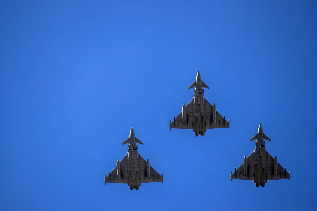 FILE - NATO fighter jets fly over Independence Square during a celebration of Lithuania's independence in Vilnius, Lithuania, Friday, March 11, 2022. As Russia���s military buildup near Ukraine a ...