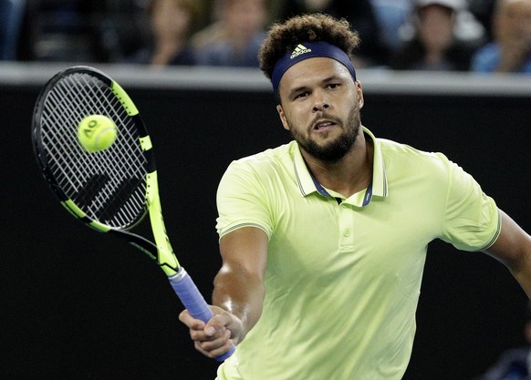 France&#039;s Jo-Wilfried Tsonga hits a forehand return to United States&#039; Kevin King during their first round match at the Australian Open tennis championships in Melbourne, Australia, Monday, Ja ...