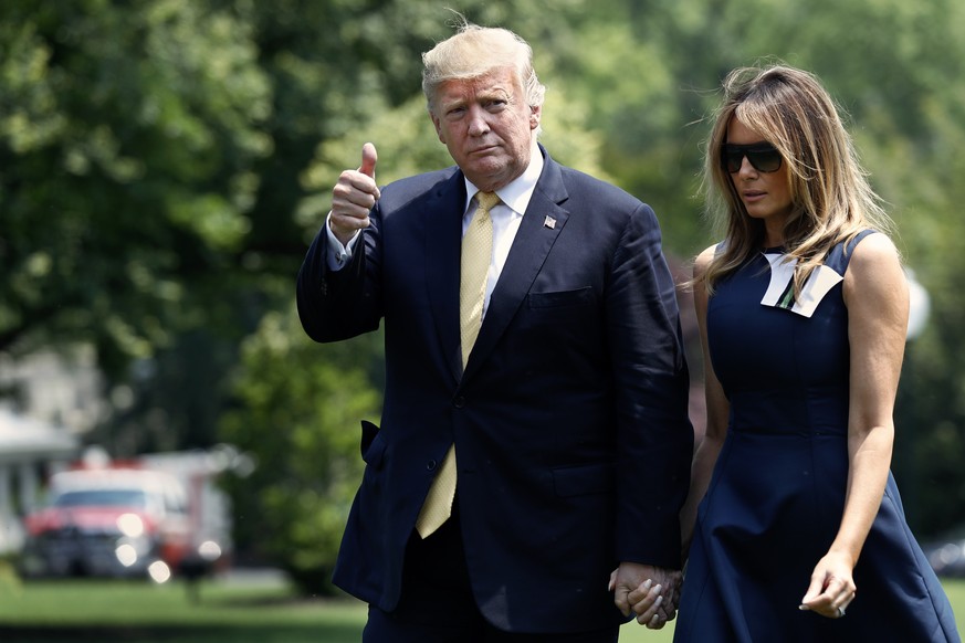 President Donald Trump makes the thumbs up sign to members of the media as he returns to the White House with first lady Melania Trump, Tuesday May 28, 2019, in Washington, after their trip to Japan.  ...