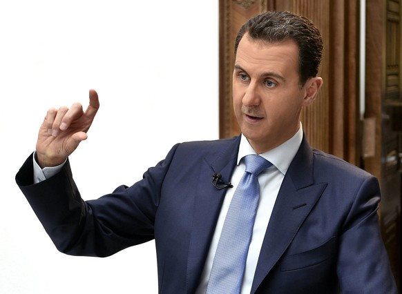 epa05893884 (FILE) - A handout photo supplied by the official Syrian Arab News Agency (SANA) 06 April 2017 (reissued 07 April 2017), showing Syrian President Bashar al-Assad speaking during an intervi ...