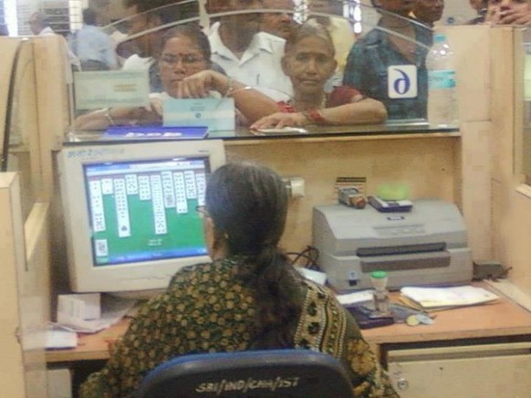 Woman plays solitaire instead of working.