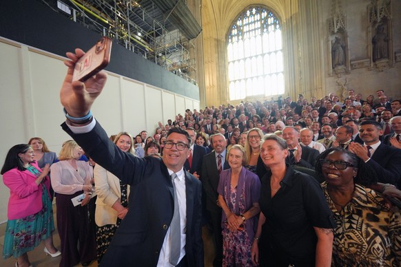 Andy Burnham with colleagues from the Parliamentary Labour Party in Westminster Hall at the Houses of Parliament in central London, as he returns to the House of Commons to take up his seat after winn ...