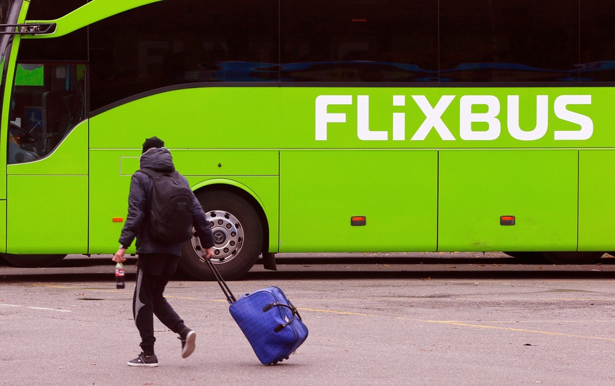 A passenger walks in front of a FlixBus intercity bus at the Carparkplatz Sihlquai bus station in Zurich, Switzerland October 27, 2016. REUTERS/Arnd Wiegmann