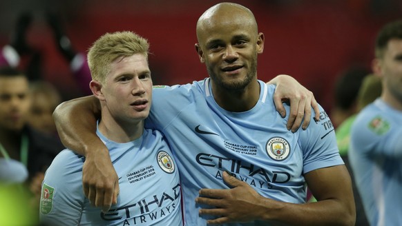 Manchester City&#039;s Vincent Kompany, right and Manchester City&#039;s Kevin De Bruyne celebrate after winning the English League Cup defeating Arsenal 3-0 in the final at Wembley stadium in London, ...