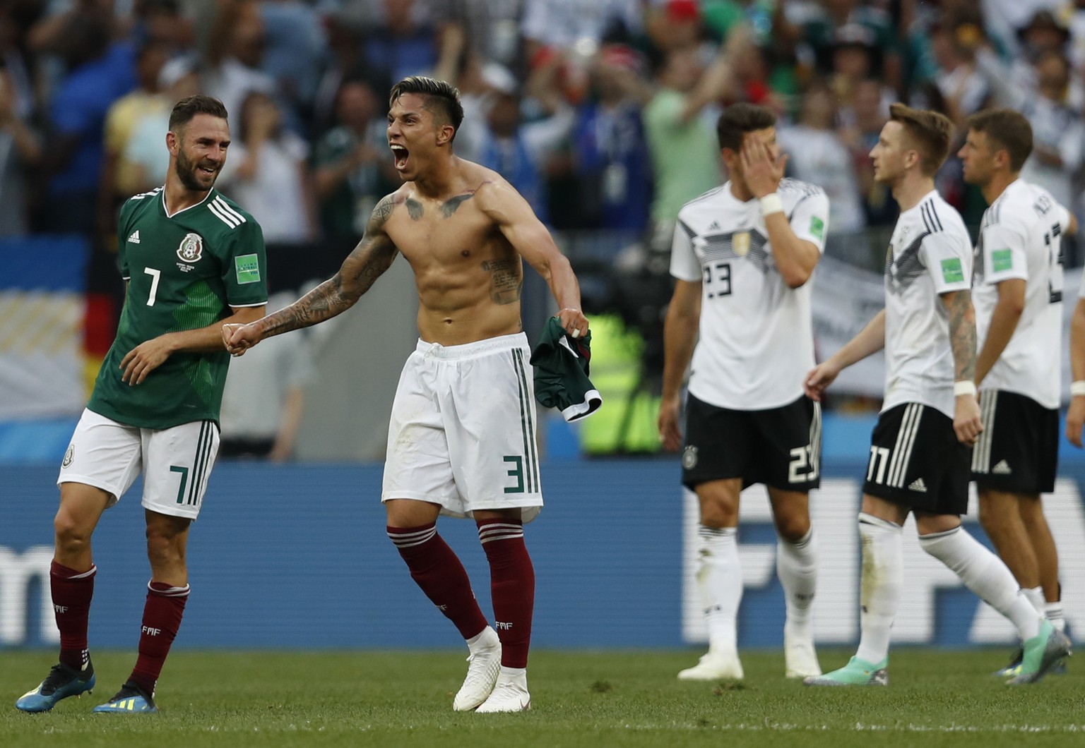 Mexico's Carlos Salcedo, second left, and Miguel Layun, left, react after Mexico defeated Germany in their group F match at the 2018 soccer World Cup in the Luzhniki Stadium in Moscow, Russia, Sunday, ...