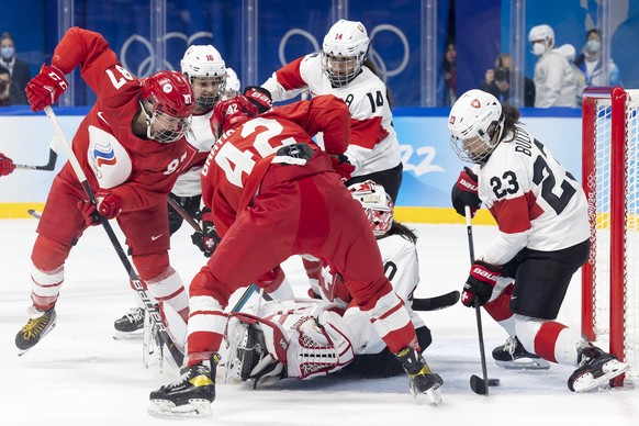 epa09748591 Russia&#039;s forward Polina Luchnikova (L) scores the 2:2 against Switzerland&#039;s goaltender Andrea Braendli during the women&#039;s ice hockey quarterfinal game between Team ROC (Russ ...