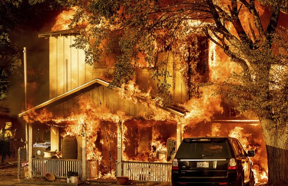 Fire consumes a home as the Sugar Fire, part of the Beckwourth Complex Fire, tears through Doyle, Calif., on Saturday, July 10, 2021. Pushed by heavy winds, the fire came out of the hills and destroye ...