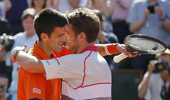 Stan Wawrinka of Switzerland (R) hugs Novak Djokovic of Serbia after winning their men&#039;s final match at the French Open tennis tournament at the Roland Garros stadium in Paris, France, June 7, 20 ...