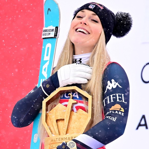 epa12640403 Winner Lindsey Vonn (C) of the USA, second placed Kajsa Vickhoff Lie (L) of Norway and third placed Jacqueline Wiles of the USA celebrate on the poduim after the Women's Downhill race ...