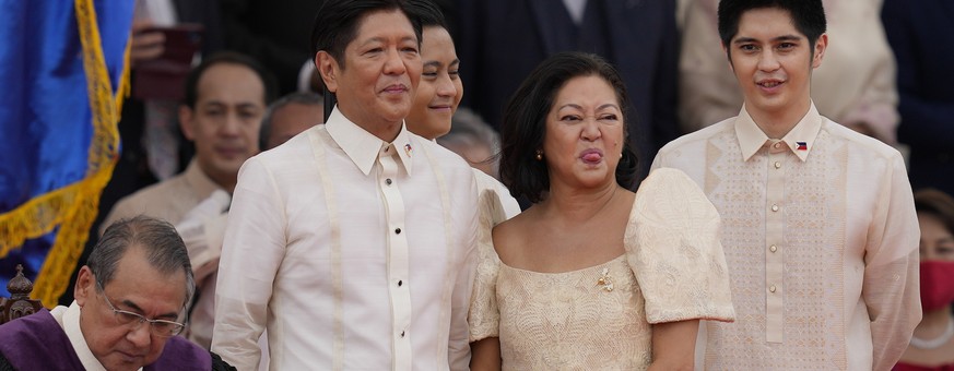 FILE - Philippines President Ferdinand Marcos Jr., second from left, and wife Maria Louise reacts after being sworn in by Supreme Court Chief Justice Alexander Gesmundo, left, during the inauguration  ...