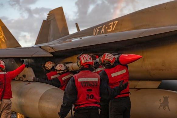 This image provided by U.S. Central Command shows Navy sailors attaching ordnance onto an F/A-18E Super Hornet aircraft on the USS Gerald R. Ford (CVN 78) in support of Operation Epic Fury, on Saturda ...