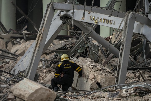 A member of a rescue team searches for survivors at the site of a deadly explosion that destroyed the five-star Hotel Saratoga, in Havana, Cuba, Friday, May 6, 2022. A powerful explosion apparently ca ...