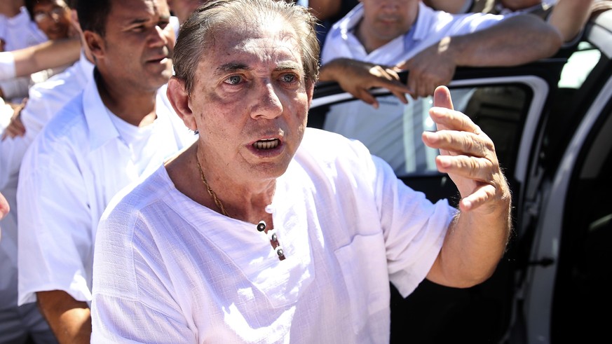 In this handout photo released by Agencia Brasil, spiritual healer Joao Teixeira de Faria, better known as John of God, arrives to the Dom Inacio Loyola House in Abadiania, Brazil, Wednesday, Dec. 12, ...