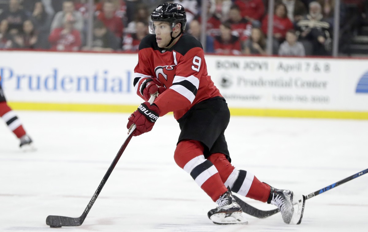 New Jersey Devils left wing Taylor Hall (9) skates the puck up before scoring a goal on the New York Islanders during the second period of an NHL hockey game, Saturday, March 31, 2018, in Newark, N.J. ...