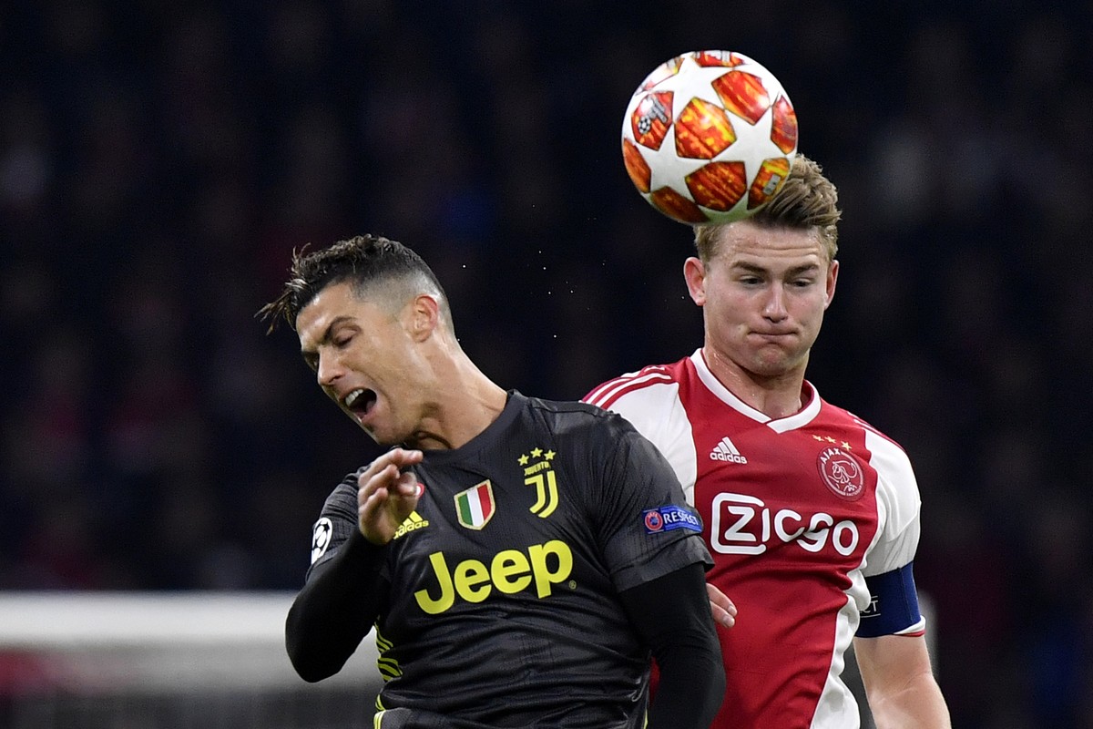 Ajax's Matthijs de Ligt, right, fights for the ball with Juventus' Cristiano Ronaldo during the Champions League quarterfinal, first leg, soccer match between Ajax and Juventus at the Johan  ...