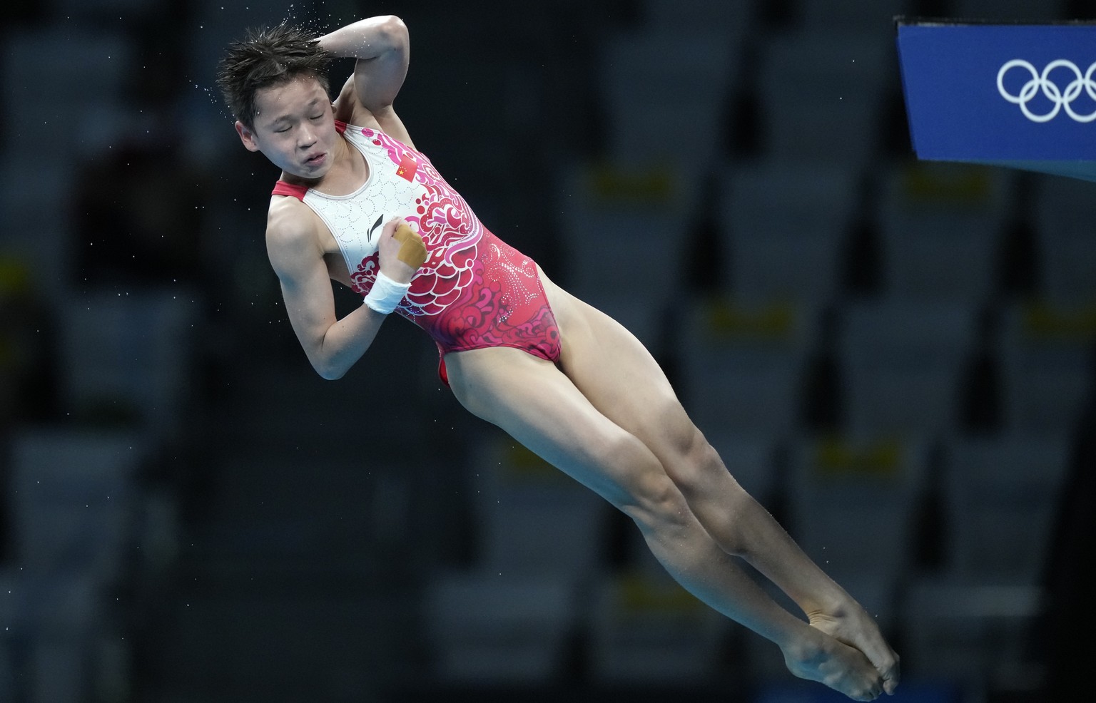 Quan Hongchan of China competes in women&#039;s diving 10m platform final at the Tokyo Aquatics Centre at the 2020 Summer Olympics, Thursday, Aug. 5, 2021, in Tokyo, Japan. (AP Photo/Dmitri Lovetsky)