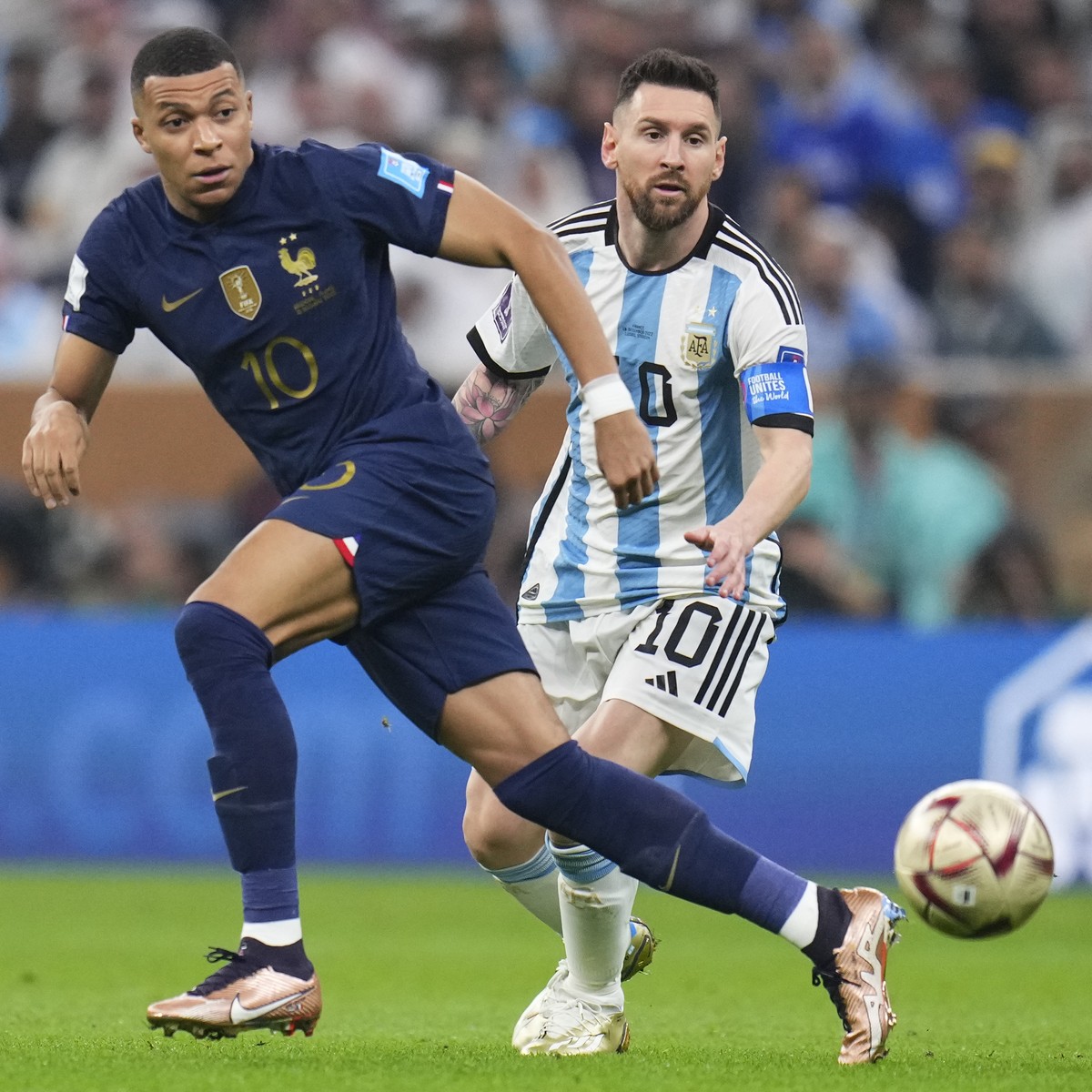 France's Kylian Mbappe and Argentina's Lionel Messi go for the ball during the World Cup final soccer match between Argentina and France at the Lusail Stadium in Lusail, Qatar, Sunday, Dec.1 ...