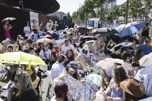 Fans, also known as &quot;Swifties,&quot; wait to attend the concert of U.S. singer and songwriter Taylor Swift as part of her &quot;The Eras Tour&quot; in front of the Letzigrund Stadium in Zurich, S ...